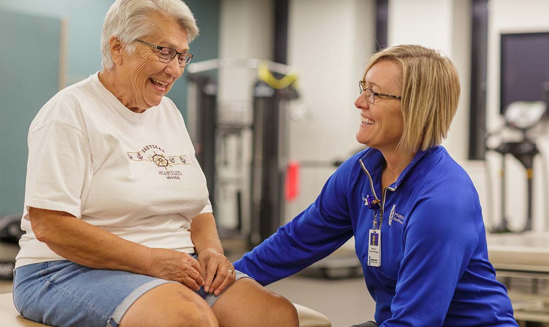 Rehab doctor with elderly patient