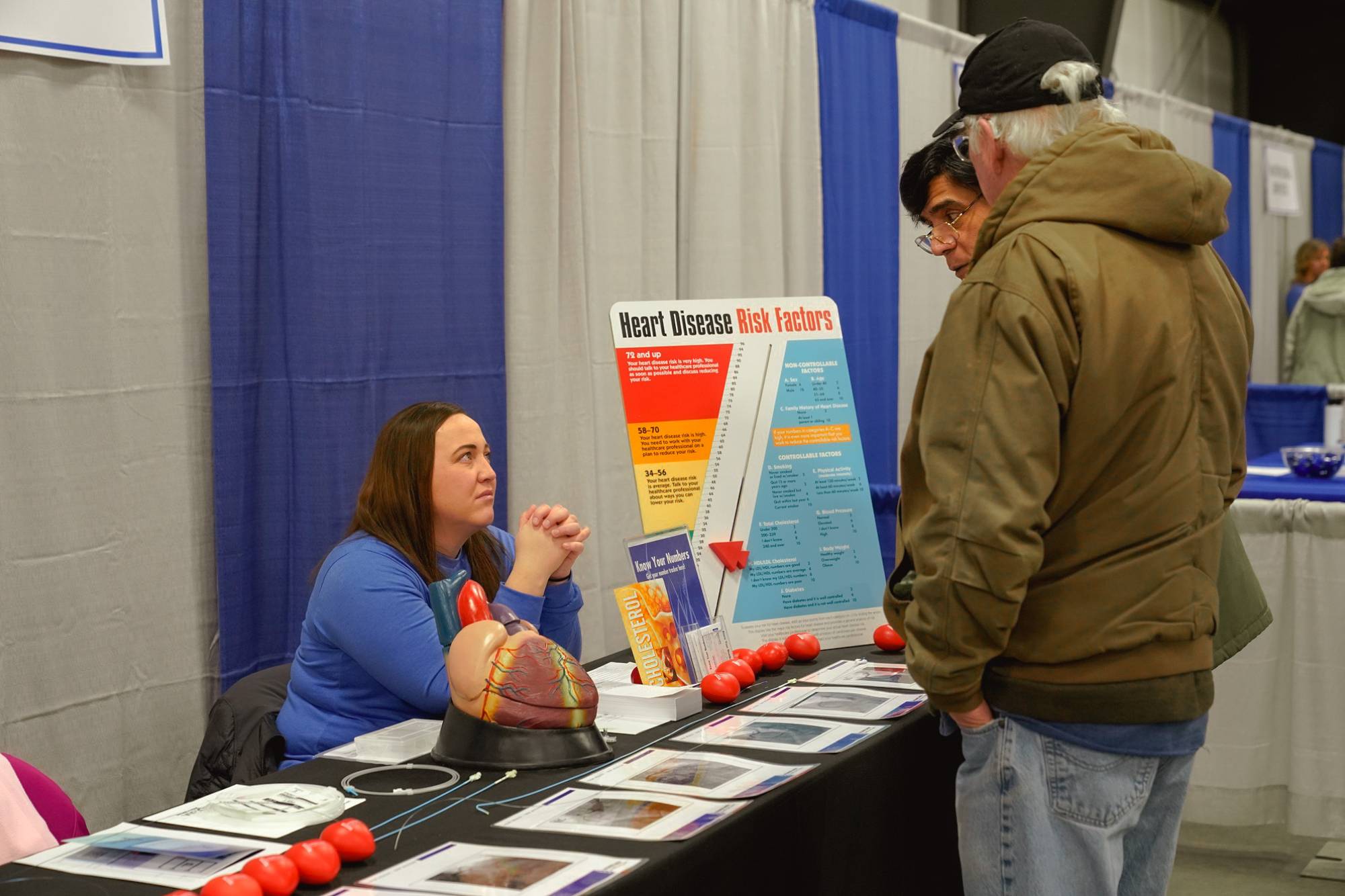 Dr. Kalaga, Interventional Cardiologist and Mindy H., Director of Cardiac Cath Lab Speak with a Health &amp; Wellness Expo Attendee