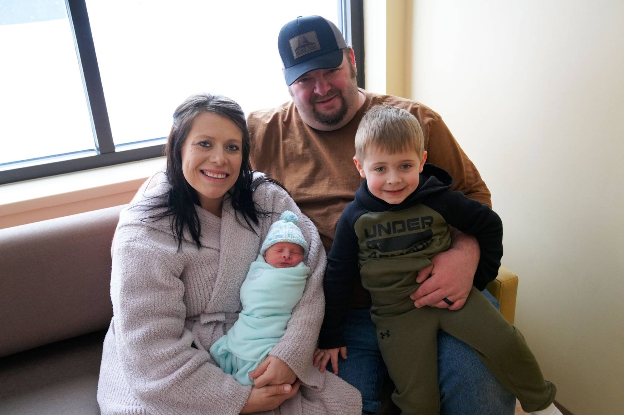 Erica and Casey Kneebone with their newborn, Clyde and son, Calvin